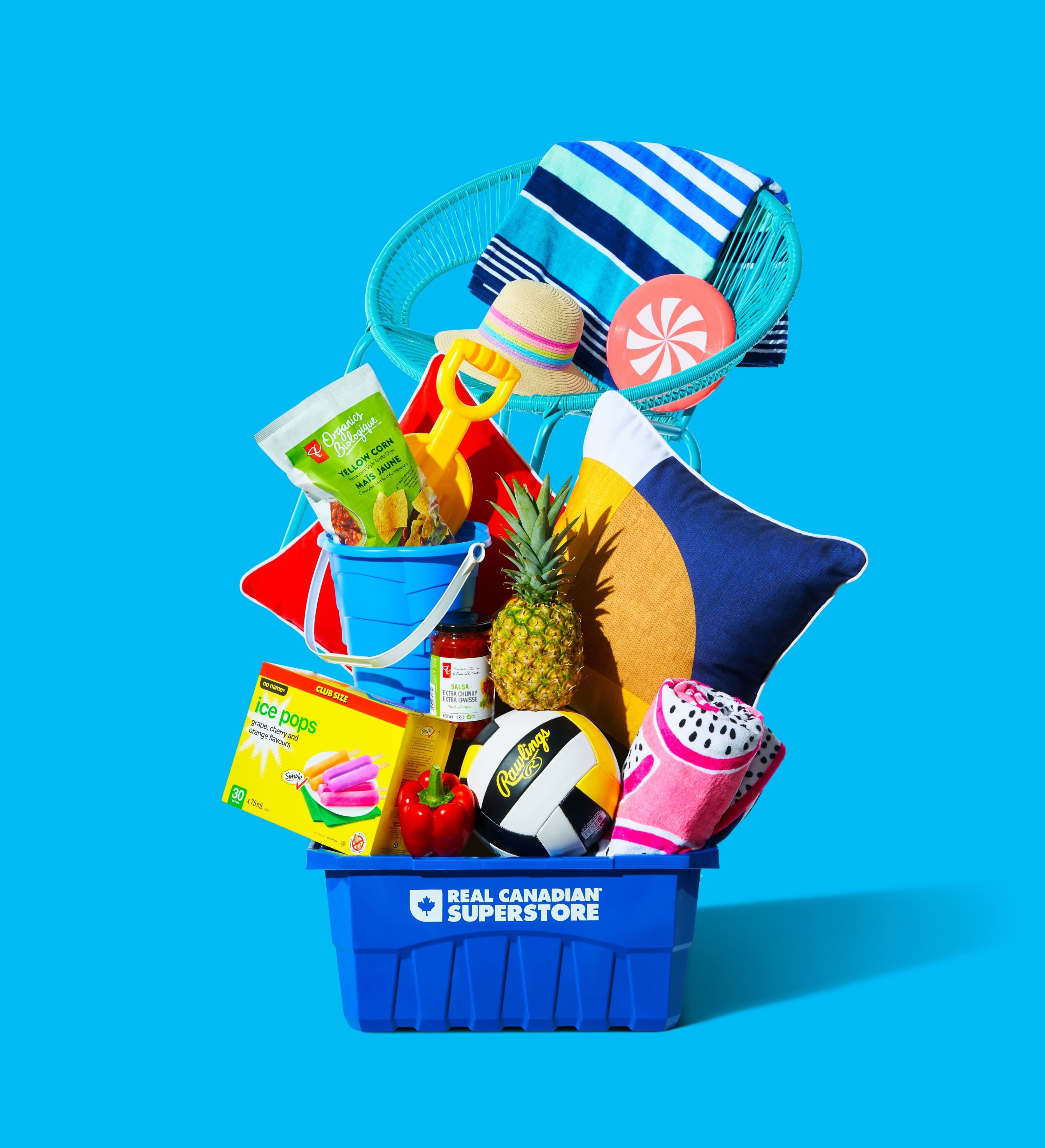 Stack of summer food and lifestyle products balancing in a tower